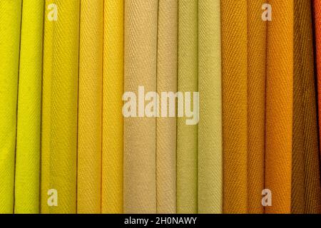 Multicolored folded fabric texture. Pile of bright folded fabric clothes. Stock Photo