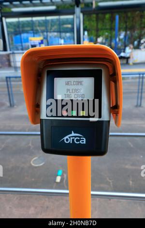 An ORCA fare card NFC reader at a Sound Transit Link light rail station in Seattle, Washington. a tap and go fare card reader Stock Photo