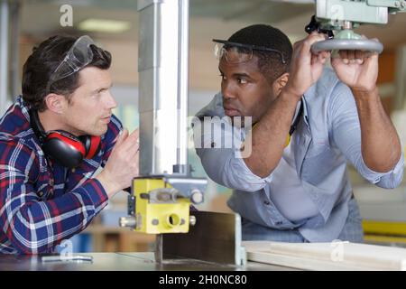 two designers working together in workshop with precision tools Stock Photo