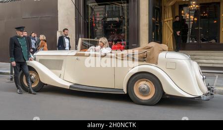A model poses in a vintage British Bentley on a Paris street France Stock Photo