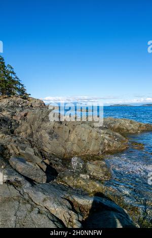 Rugged shoreline of Moorecroft Regional Park, looking north across the Strait of Georgia on a sunny day, Vancouver Island, British Columbia, Canada