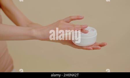 A woman is using a cream pot Stock Photo