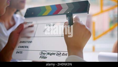 Hand is writing on a cinema clapperboard Stock Photo