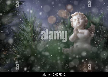 Christmas angel on abstract blurry background and golden lights Stock Photo