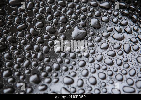 Water droplets rain drops on a silver metal tray Stock Photo