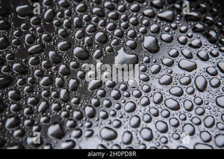 Water droplets rain drops on a silver metal tray Stock Photo