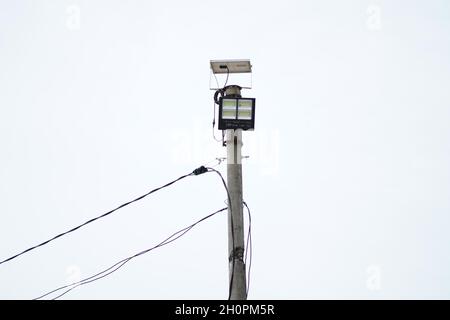 A solar sport light was installed on a pole to light the coverage area at night. The solar sport light is used to light the construction store at night. Stock Photo
