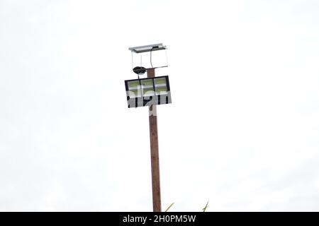 A solar sport light was installed on a pole to light the coverage area at night. The solar sport light is used to light the construction store at night. Stock Photo
