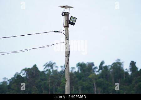 A solar sport light was installed on a pole to light the coverage area at night. The solar sport light is used to light the construction store at night. Stock Photo