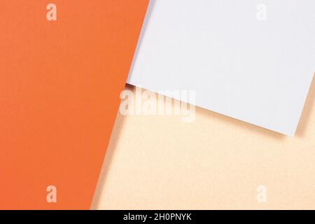 Creative abstract geometric brown craft paper and colored paper background in orange, light gray colors. Top view, copy space. Stock Photo
