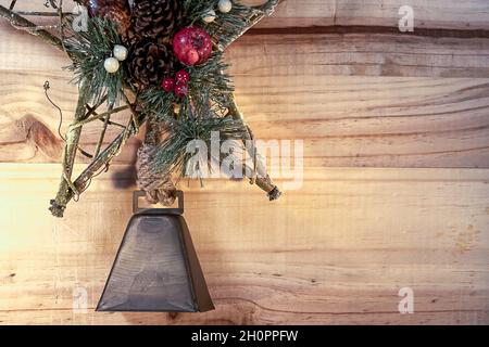 Bell and Star Christmas concept on wooden plank background. Stock Photo