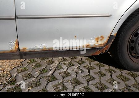 Rusting door sill in an old car. Weather damage in vehicle. Stock Photo