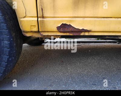 Rusting door sill in an old car. Weather damage in vehicle. Stock Photo
