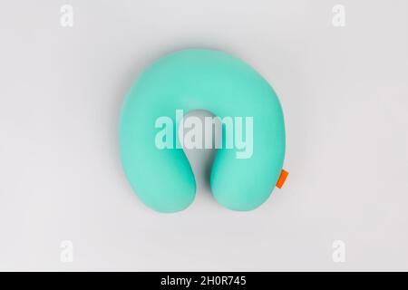 Travel blue sleeping pillow or Neck Pillow on grey background. Stock Photo