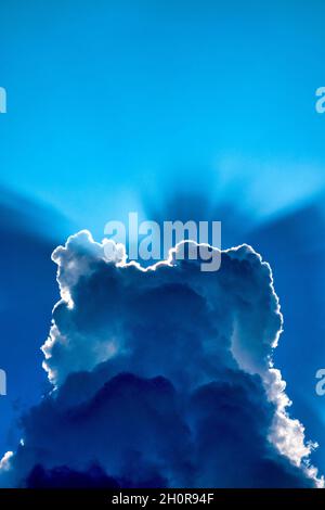 Sunbeams behind the clouds Stock Photo
