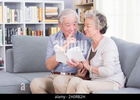 Stay-at-home elderly couple reading books Stock Photo
