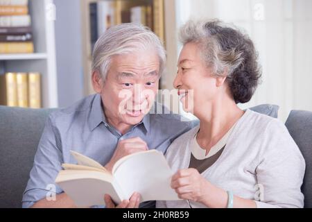 Stay-at-home elderly couple reading books Stock Photo