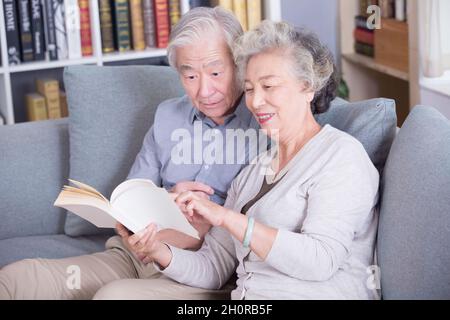 Stay-at-home elderly couple reading books Stock Photo