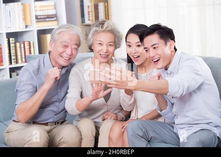 The happy family using their phones Stock Photo
