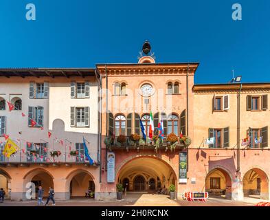 Alba, Cuneo, Piedmont, Italy - October 12, 2021: town hall with the banners of the districts of the donkey race (Palio degli Asini)  a Stock Photo