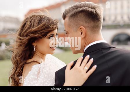 Wedding day, portrait close-up of bride and groom tenderly look at each other, happy together. Lifestyle Stock Photo
