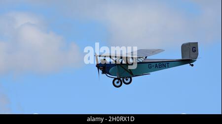 Vintage 1931 Civilian Coupe 02 G-ABNT  aircraft in flight  with blue sky and clouds. Stock Photo