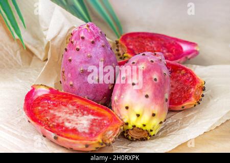 Bright exotic pink prickly pear cactus fruit or opuntia on light background. Stock Photo
