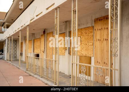Condemned apartment building or hotel boarded up with plywood Stock Photo