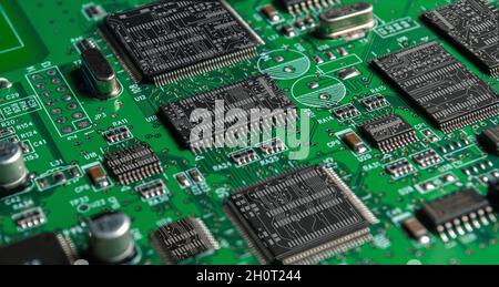 printed circuit board with surface mounted passive and active circuit components close up Stock Photo