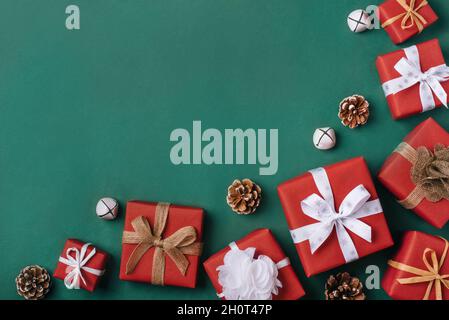 Gift boxes with white and brown bows on a green backdrop. Stock Photo