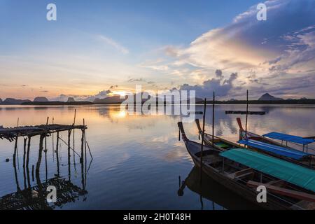 Ban Sam Chong Tai and colorful sunrises that emerges behind the giant limestone mountains, Phang-nga, Thailand Stock Photo