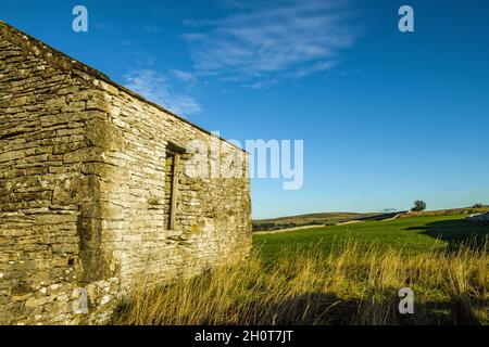 An old derelict limestone barn at the top of Ravenstonedale in Cumbria on an October morning Stock Photo
