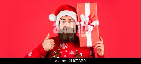 showing thumb up. new year shopping discounts. ready for xmas gifts and presents. Christmas party time. bearded santa claus in hat. celebrate the Stock Photo