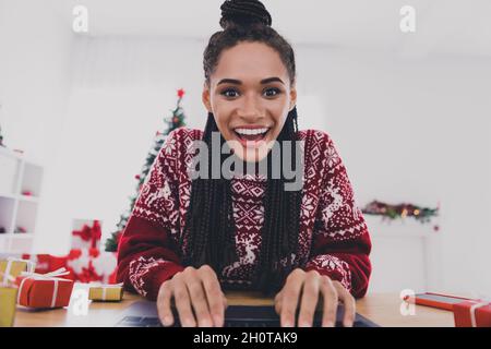 Portrait of attractive amazed cheerful girl using laptop talking chatting on web typing message workshop at home indoors Stock Photo