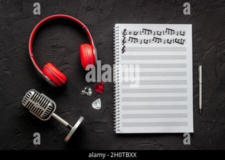 Handwritten music sheets and headphones, top view. Compose music concept Stock Photo