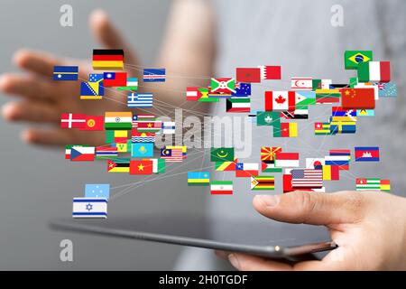 3D rendering of international flags floating on top of a man's smartphone Stock Photo