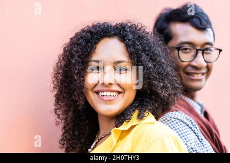 South american woman and indian man having fun together - Multiracial couple standing outdoor near university backyard -Friendship, love and multiethn Stock Photo