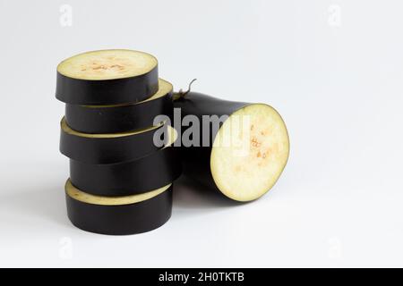 fresh and raw sliced purple eggplant isolated on white background, organic vegetables, creative concept, healthy food Stock Photo
