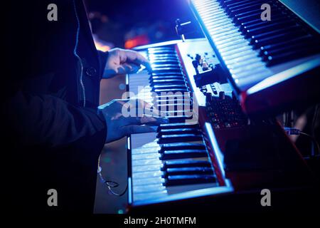Hands of a musician playing keyboard in concert Stock Photo