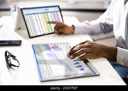 Electronic Spreadsheet Analyst Or Auditor Using Software On Hybrid Laptop Stock Photo