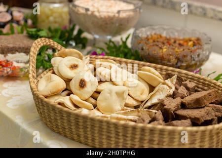 Detail of a basket with assorted breads, on a party buffet table. Stock Photo