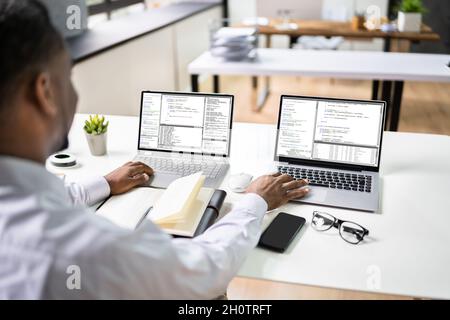 African American Programmer Man Coding On Computer Stock Photo