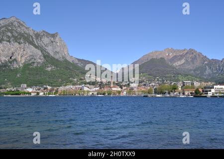 Stunning Panoramic View of a Large Area of Lake Como in Lecco Bay on a Sunny Day in Spring with Mountains in the Background and Rippling Blue Waters. Stock Photo