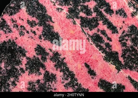 Rhodonite is a manganese inosilicate and member of the pyroxenoid group of minerals, crystallizing in the triclinic system Stock Photo