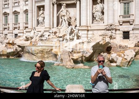 Tourists taking selfies and posing for travel images by Fontana Trevi in Rome, Italy Stock Photo