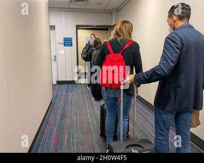 Orlando FL USA - September 26, 2021:   People waiting in the jetway to board an American airplane at the Orlando International Airport in Orlando, Flo Stock Photo