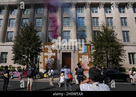 Washington, United States. 14th Oct, 2021. Demonstrators with climate change activist group Extinction Rebellion scale the exterior of the Chamber of Commerce building and release colored smoke during a protest in Washington, DC on Thursday, October 14, 2021. Photo by Sarah Silbiger/UPI Credit: UPI/Alamy Live News Stock Photo