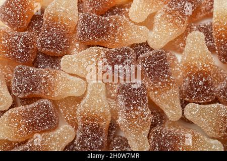 Cola-flavored chewable bottle-shaped gummy candies covered with sugar crystals Stock Photo
