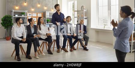Female startup team leader listens to the suggestions of her colleagues at a meeting in the office. Stock Photo