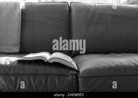 open book or bible on sofa or couch with morning light and copy space Stock Photo
